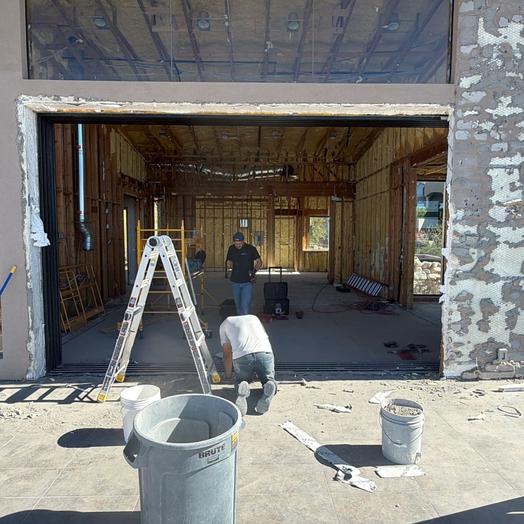 Kogan crew working an interior strip-out with the floor protected and debris contained
