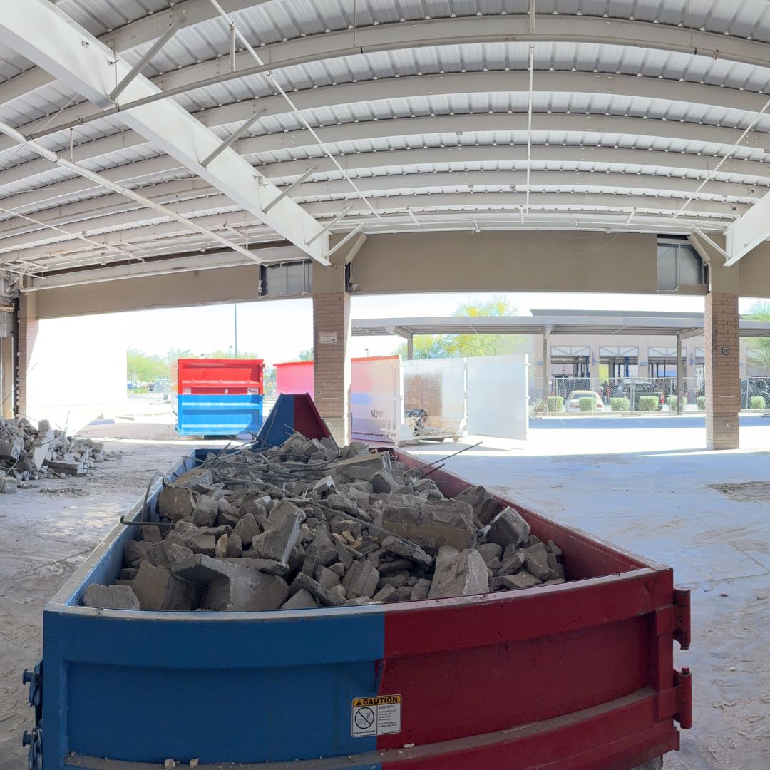 Container loaded with sorted concrete debris inside a commercial interior demolition
