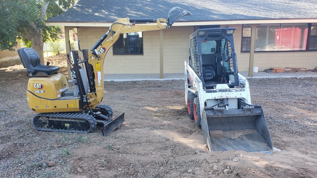 Mini excavator and skid steer on a Phoenix residential demolition site