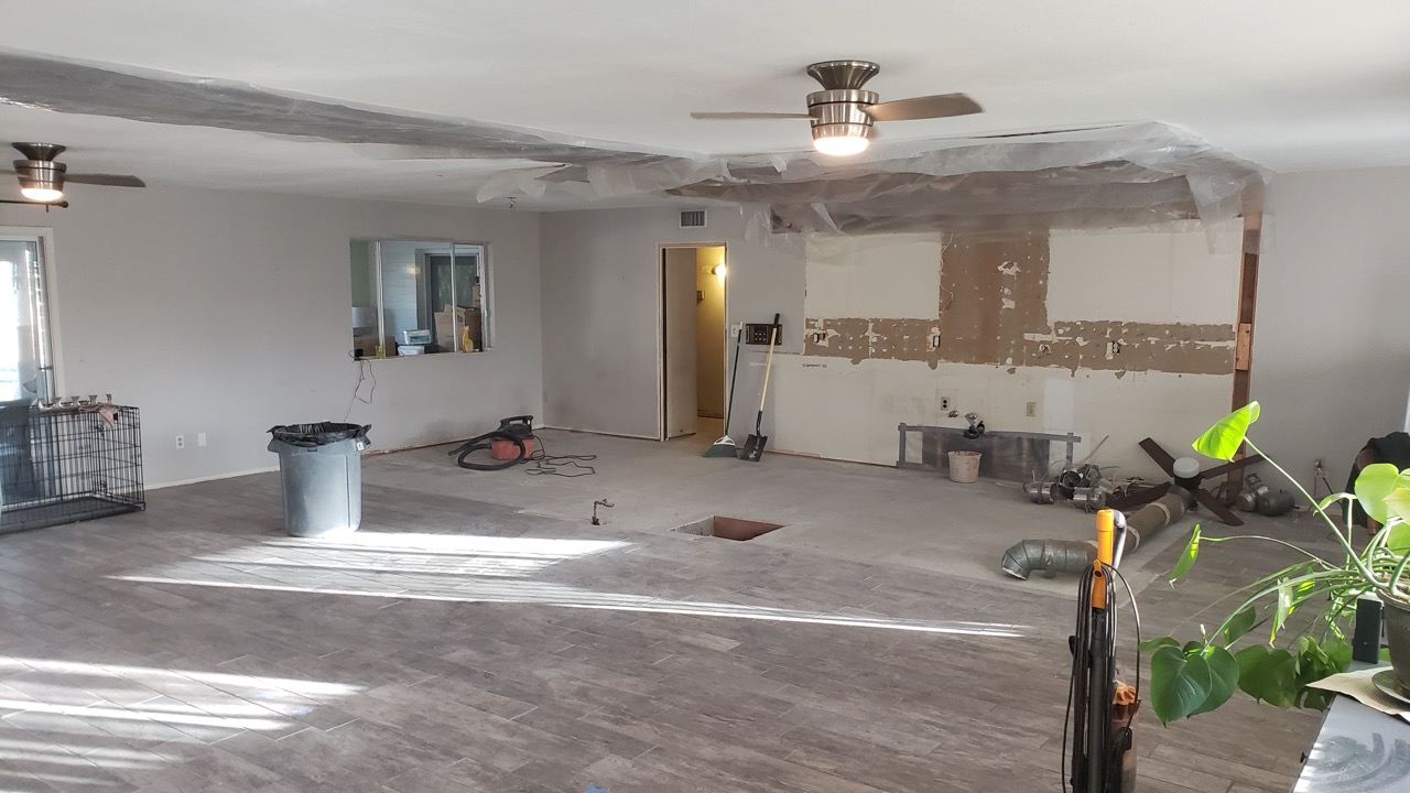 Residential interior cleared down to the subfloor after demolition