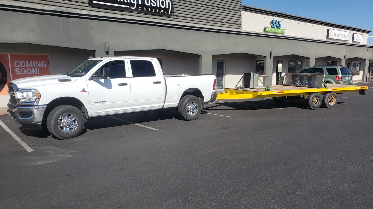 Kogan truck and equipment trailer outside a Phoenix retail build