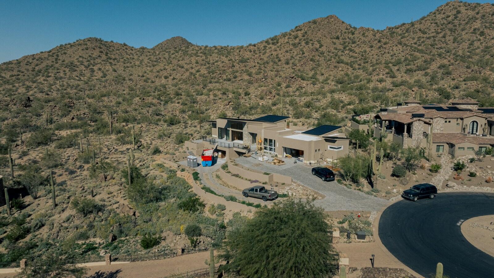 Wide aerial view of a Kogan LLC project on a desert hillside in Arizona