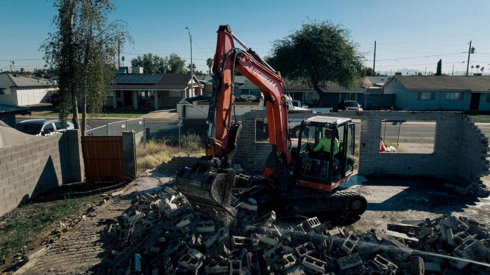 Aerial view of a Kogan LLC excavator taking down a structure in the Phoenix Valley