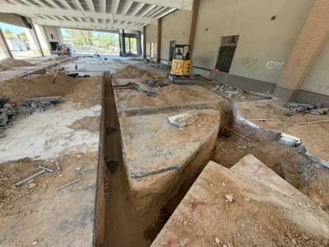 Saw-cut trench opened through a concrete slab inside a Phoenix building
