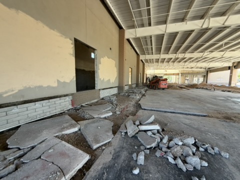 Cut concrete slab sections broken out and stacked for removal