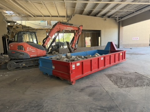 Debris dumpster loaded inside a commercial strip-out