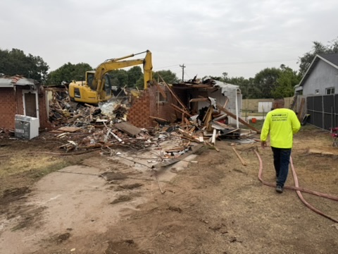 Excavator taking down a Phoenix house with the crew on the hose