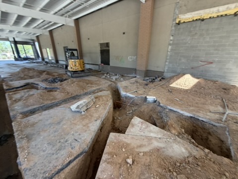 Trenches cut into a commercial floor slab ahead of new services