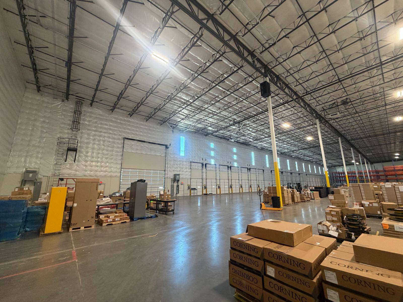 A large commercial warehouse cleared and swept, with stock staged on the floor, Phoenix, Arizona