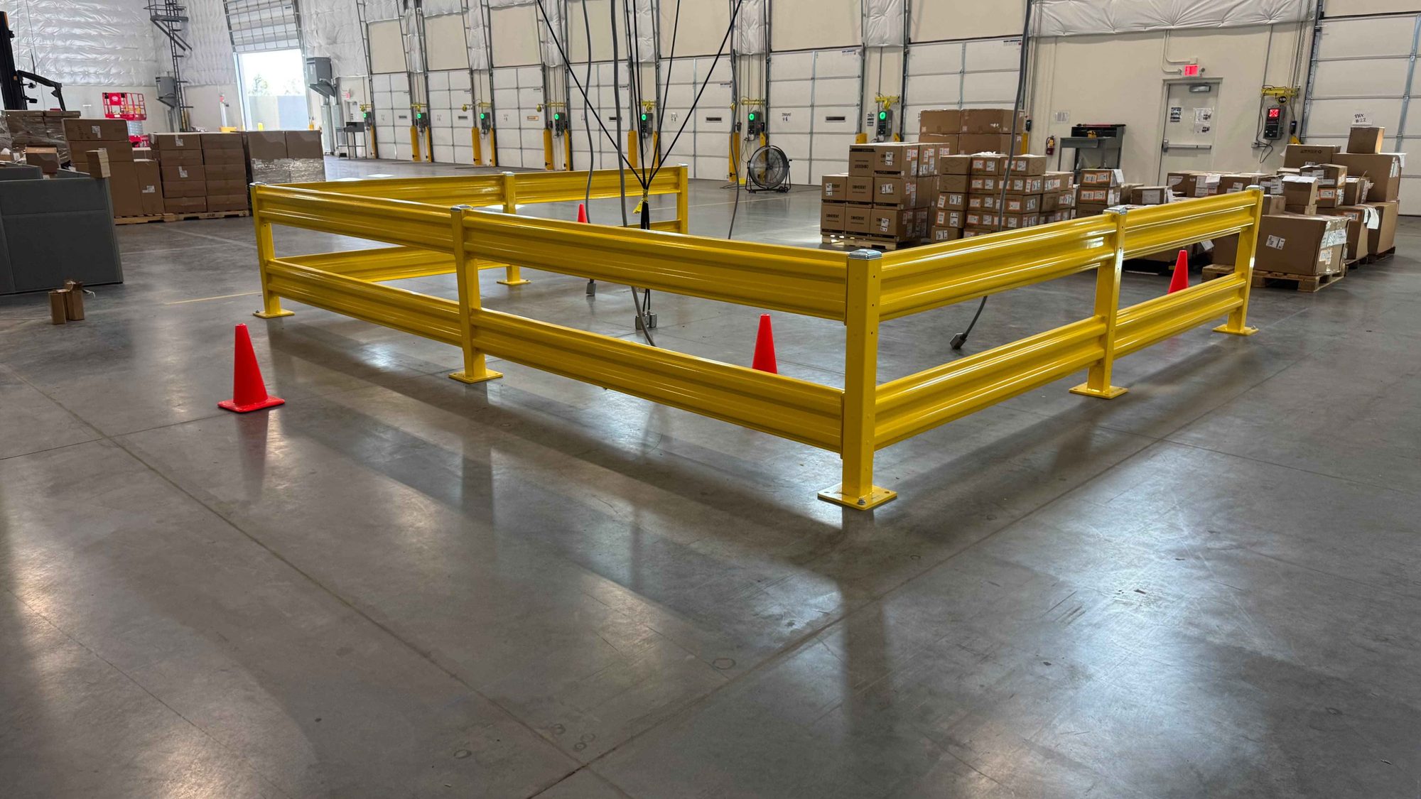 Bolted steel guardrail enclosure near the loading docks of a distribution warehouse